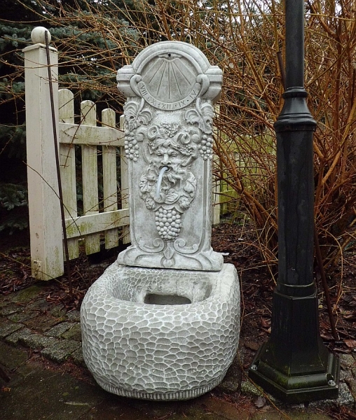 Wall fountain "wine god Bacchus" and sundial Wall fountain "wine god Bacchus" and sundial
